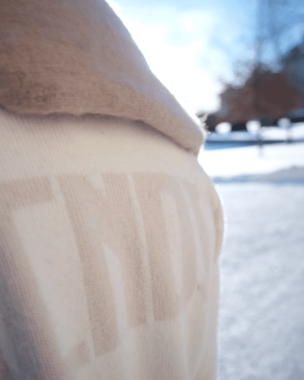 Close-up of soft SCNDI ivory knit fabric with subtle texture
