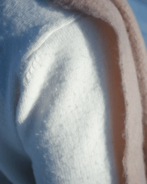 Close-up of soft SCNDI ivory knit fabric with subtle texture