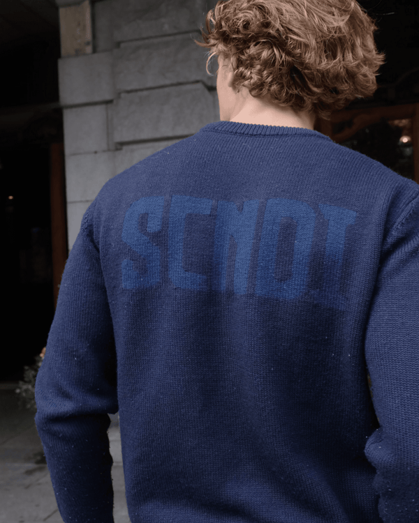 Back view of navy sweater with refined minimalist design